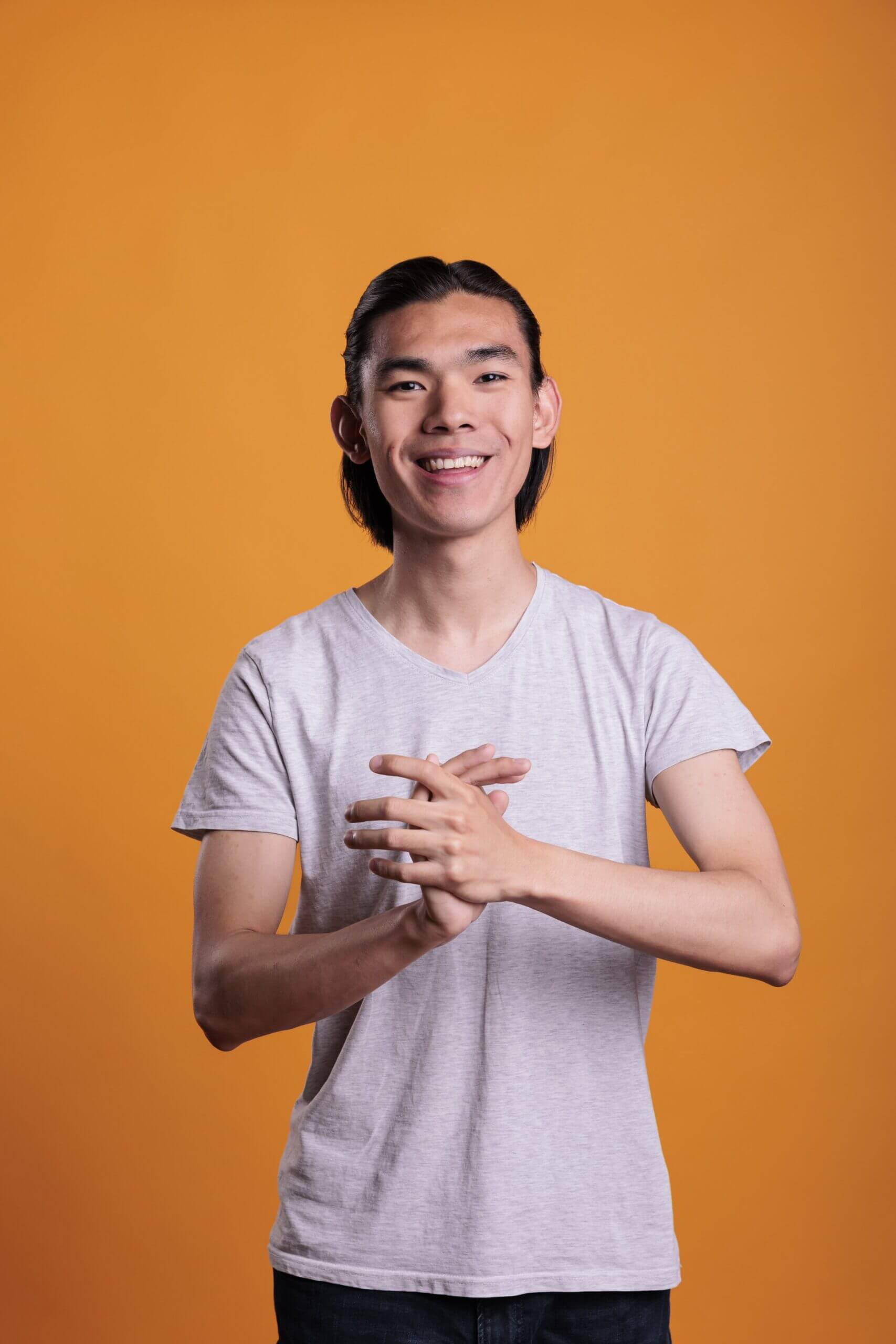young-cheerful-smiling-asian-man-applauding-2025-02-19-01-34-50-utc-scaled.jpg